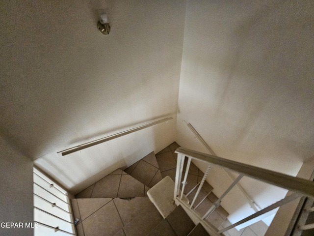 stairs featuring tile patterned floors