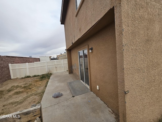 view of property exterior with a patio area