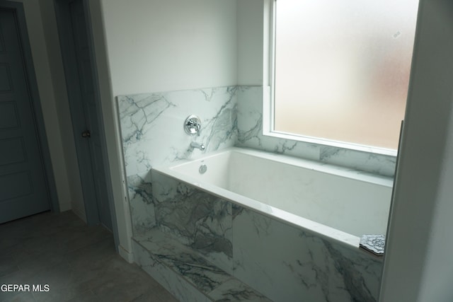 bathroom with tiled bath