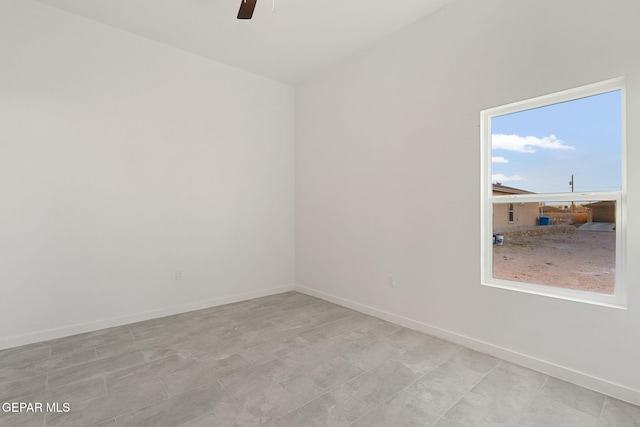 unfurnished room featuring a ceiling fan and baseboards