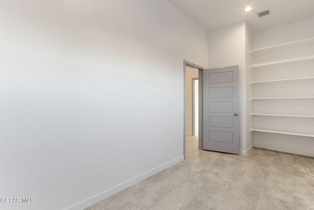 unfurnished room featuring visible vents and baseboards