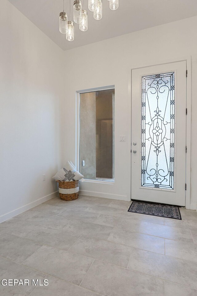 entryway featuring baseboards