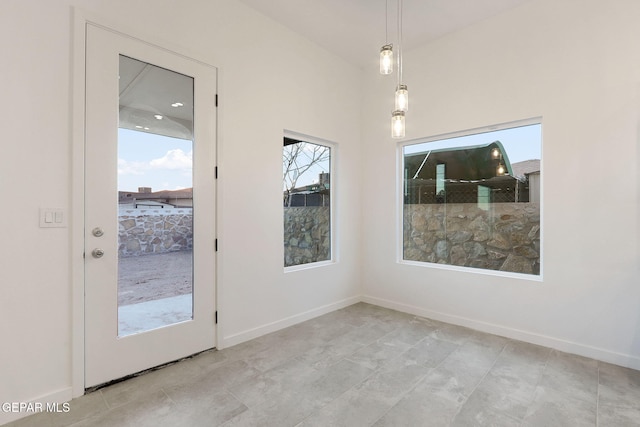 unfurnished dining area featuring baseboards