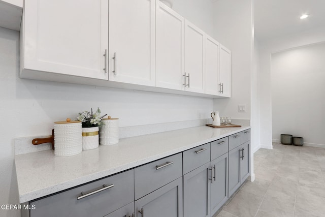 bar with recessed lighting and baseboards