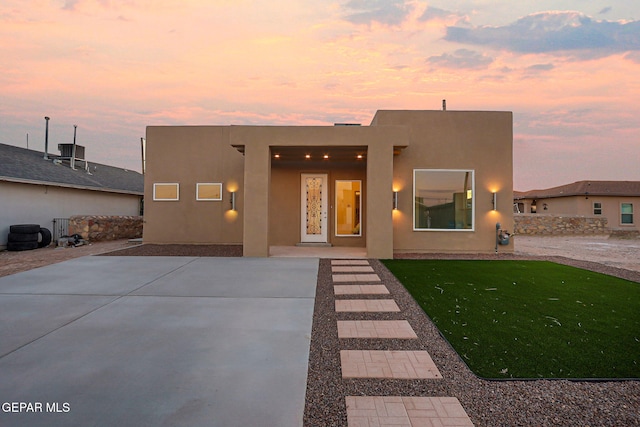 pueblo-style home featuring stucco siding