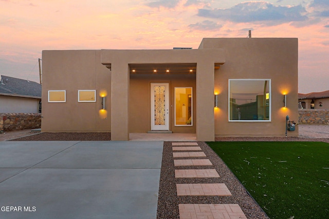 property entrance with stucco siding