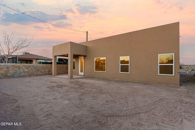 back of property with a patio, fence, and stucco siding