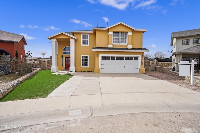 view of property featuring a garage and a front yard