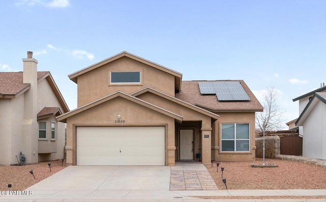 view of front of property featuring a garage and solar panels