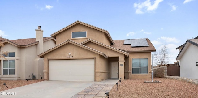 view of front of home featuring a garage and solar panels