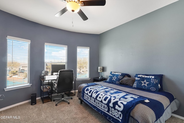 carpeted bedroom featuring ceiling fan and baseboards