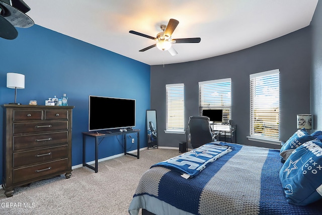 bedroom with a ceiling fan, light colored carpet, and baseboards