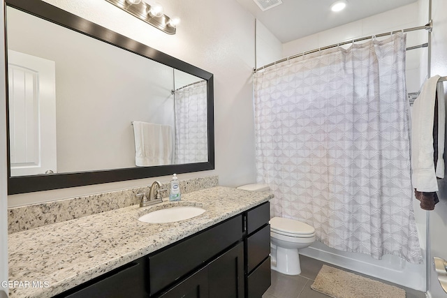 bathroom featuring shower / bath combination with curtain, visible vents, toilet, vanity, and tile patterned flooring