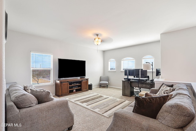 living room featuring baseboards and light colored carpet