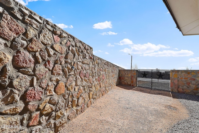 view of yard featuring fence and a gate