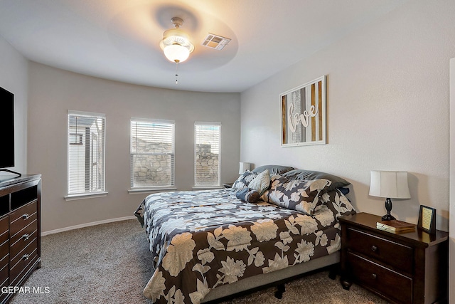 carpeted bedroom featuring visible vents and baseboards