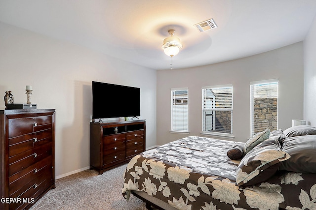 bedroom featuring light colored carpet, visible vents, and baseboards