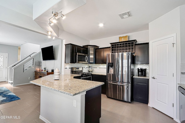 kitchen featuring light stone counters, light tile patterned floors, visible vents, backsplash, and appliances with stainless steel finishes