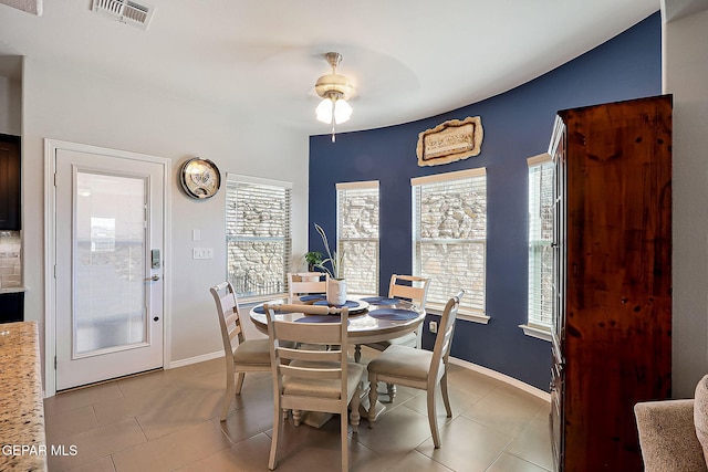 dining area featuring ceiling fan, light tile patterned floors, and a wealth of natural light