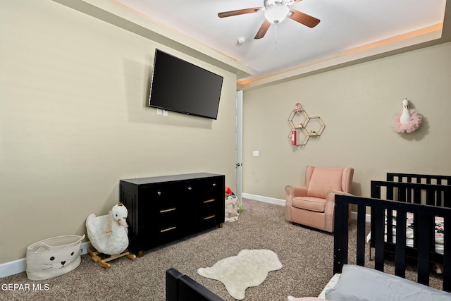 bedroom with a crib and carpet flooring