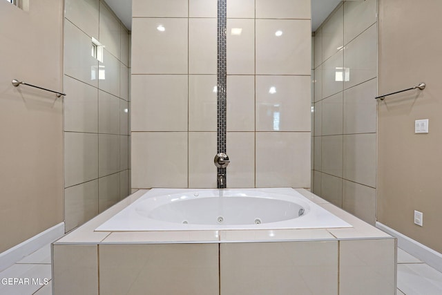 bathroom with tile walls and tiled bath