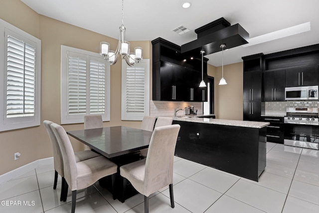 tiled dining space with an inviting chandelier