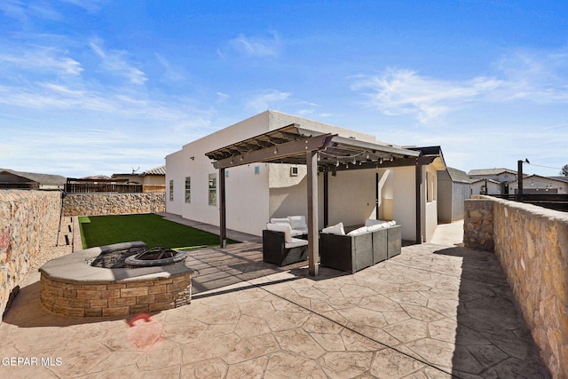 view of patio / terrace featuring a pergola and an outdoor living space with a fire pit