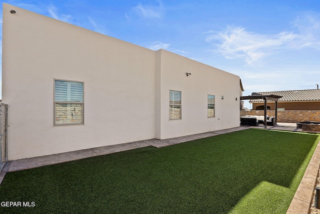 rear view of house with a pergola, a lawn, and a patio