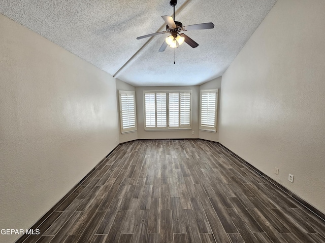 spare room featuring ceiling fan, dark hardwood / wood-style floors, and a textured ceiling