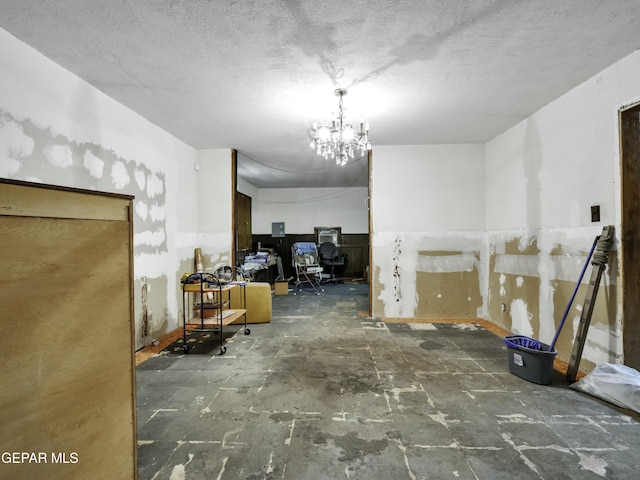 interior space featuring a chandelier and a textured ceiling