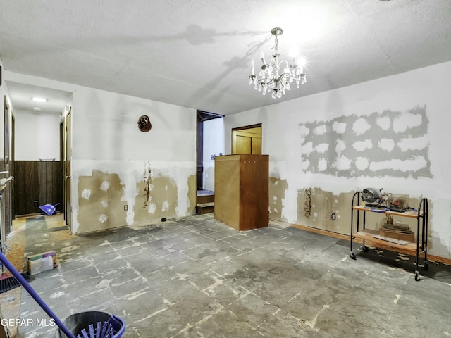 interior space with an inviting chandelier and a textured ceiling