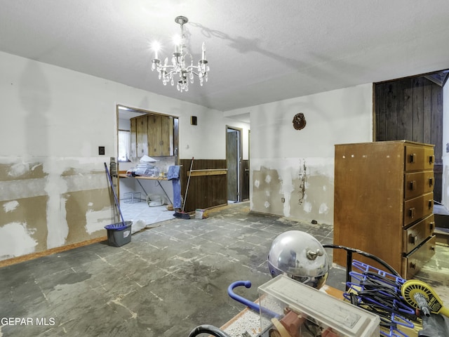 interior space with a chandelier and a textured ceiling