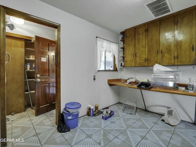 kitchen with light tile patterned floors and a textured ceiling