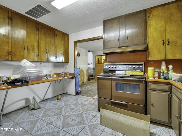 kitchen with range and a textured ceiling