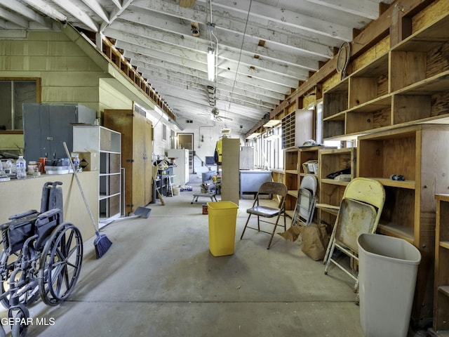 interior space with concrete flooring and vaulted ceiling