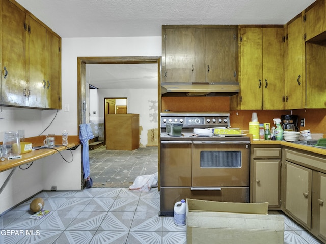 kitchen featuring range and a textured ceiling