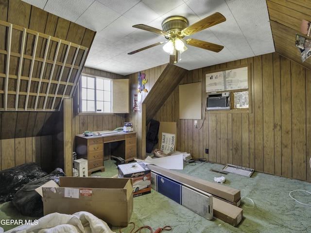 interior space featuring lofted ceiling, cooling unit, ceiling fan, and wood walls