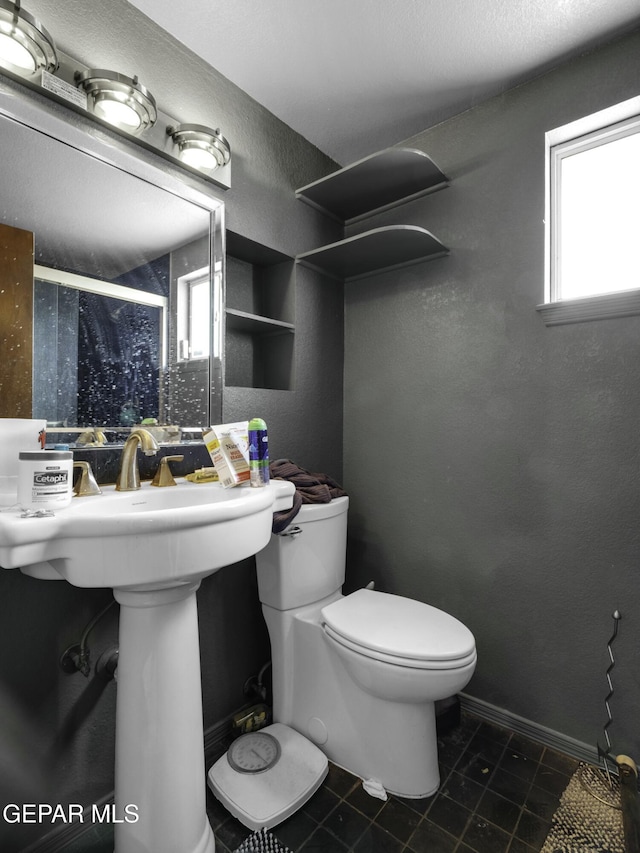 bathroom with tile patterned floors and toilet