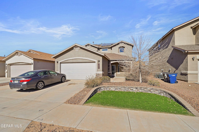 view of front of house with a garage and solar panels