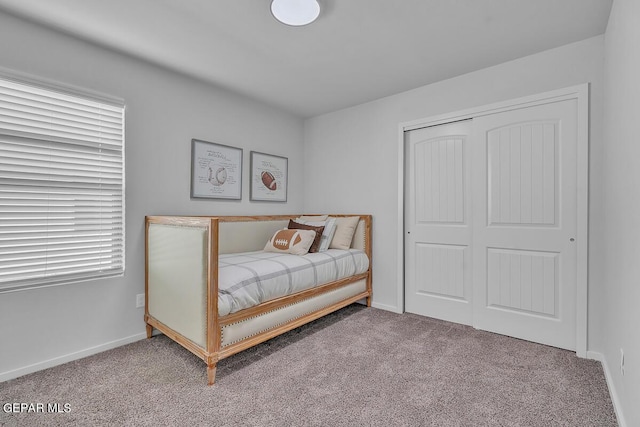 carpeted bedroom with a closet