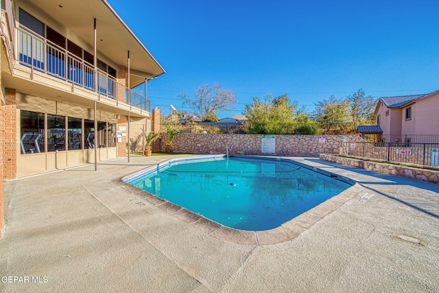 view of swimming pool featuring a patio area