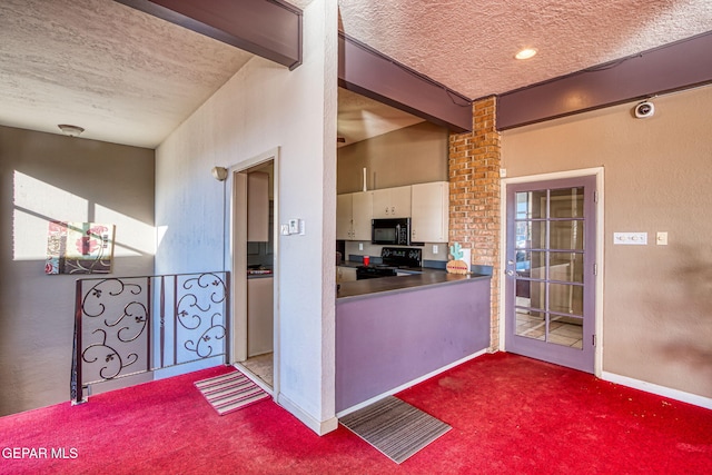 kitchen featuring beam ceiling, carpet floors, a textured ceiling, and black appliances