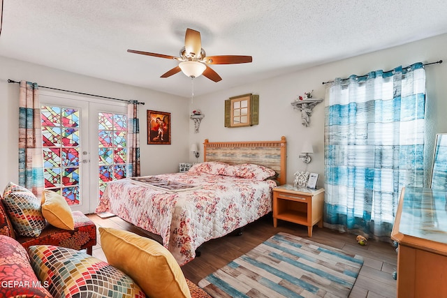 bedroom with french doors, access to exterior, a textured ceiling, and hardwood / wood-style flooring