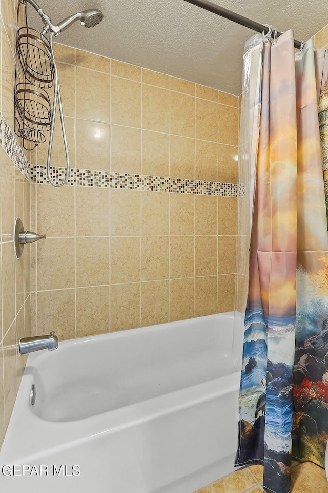 bathroom with a textured ceiling and shower / bath combo