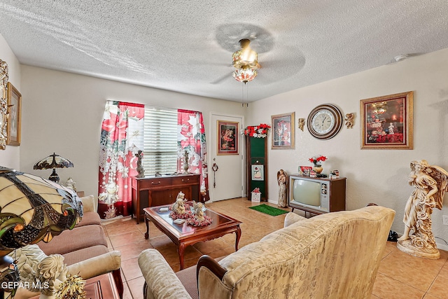 tiled living room with a textured ceiling and ceiling fan