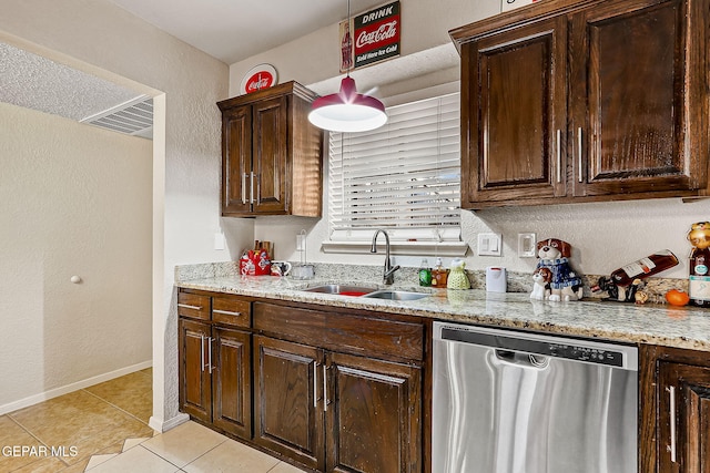 kitchen featuring sink, light tile patterned floors, dishwasher, light stone counters, and dark brown cabinetry