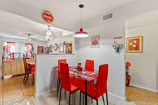 dining room featuring tile patterned flooring, a textured ceiling, and ceiling fan