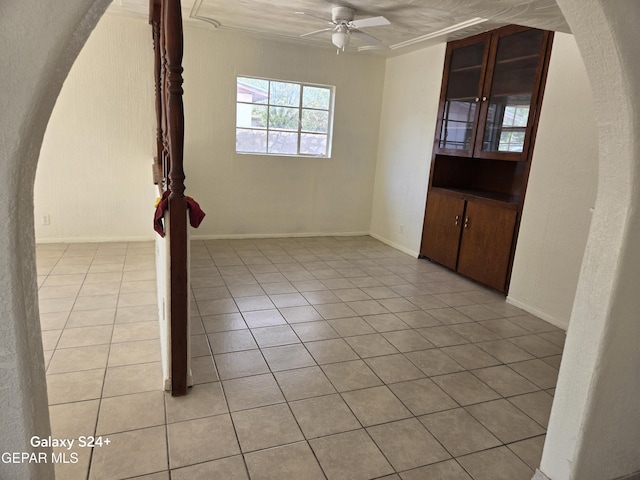 empty room featuring light tile patterned floors and ceiling fan