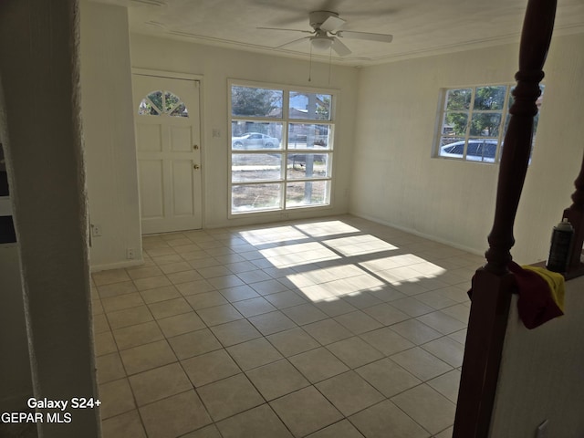 interior space featuring ceiling fan, ornamental molding, a healthy amount of sunlight, and light tile patterned flooring