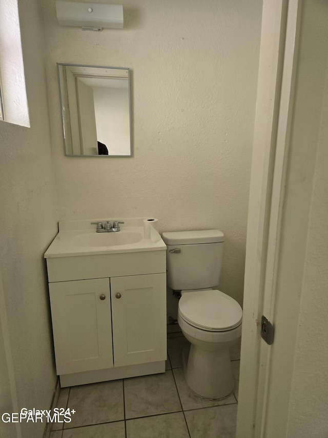 bathroom featuring vanity, a wall mounted air conditioner, tile patterned flooring, and toilet